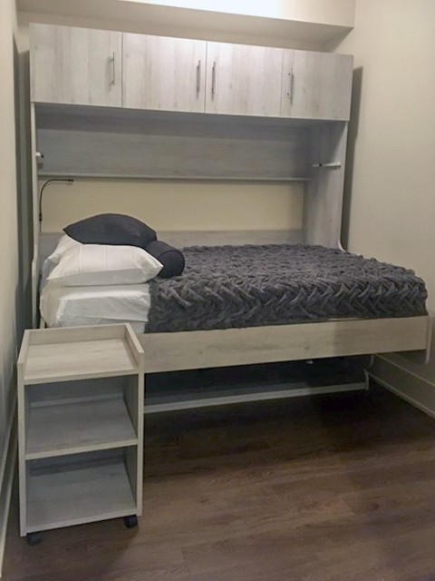 The nightstand becomes office storage once the bed is folded away, below..