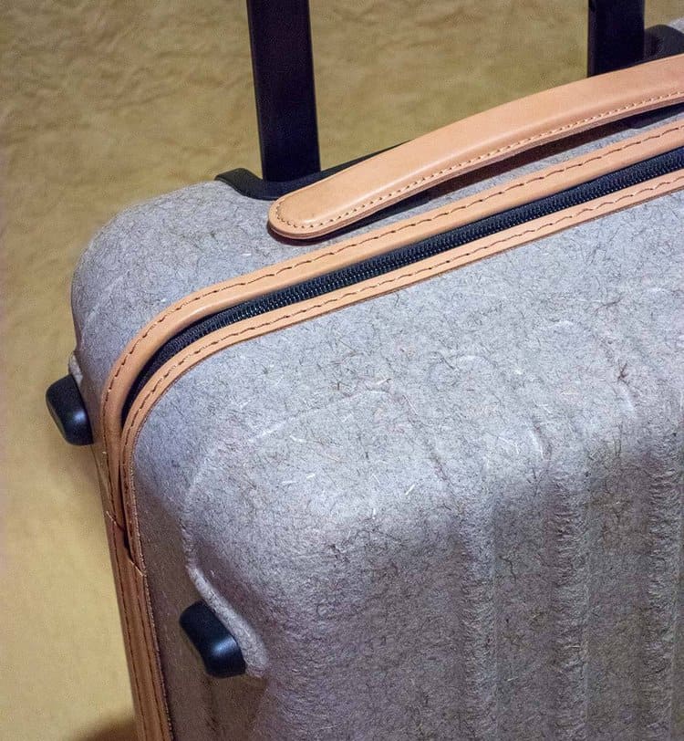 suitcase of heathered gray plant fiber with leather accents