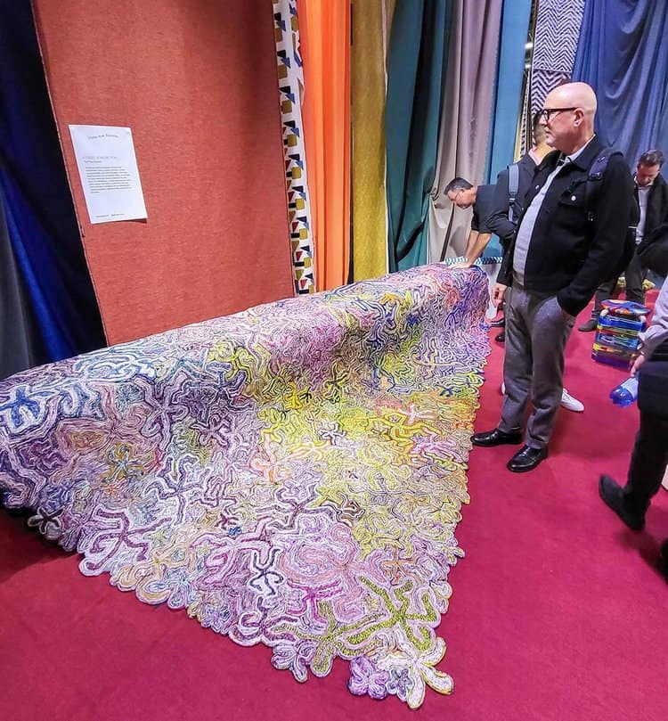 brightly colored flower pattern rug on display at tradeshow