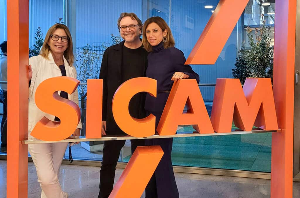 Friends pose at the SICAM expo sign
