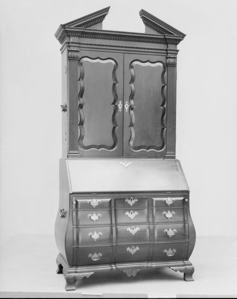 Boston mahogany desk and bookcase with a swelling bombé lower case, slant-front desk and broken-pediment top